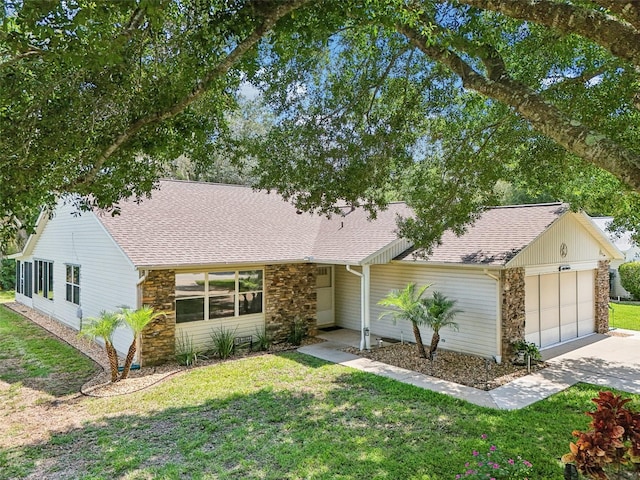 1011 Dundee Cir, Leesburg, FL 34788 - mid-century modern home with stone siding, a garage, roof with shingles, concrete driveway, and a front lawn