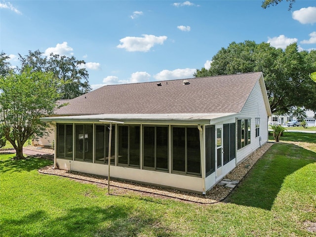 1011 Dundee Cir, Leesburg, FL 34788 - back of house with a sunroom, a yard, and roof with shingles