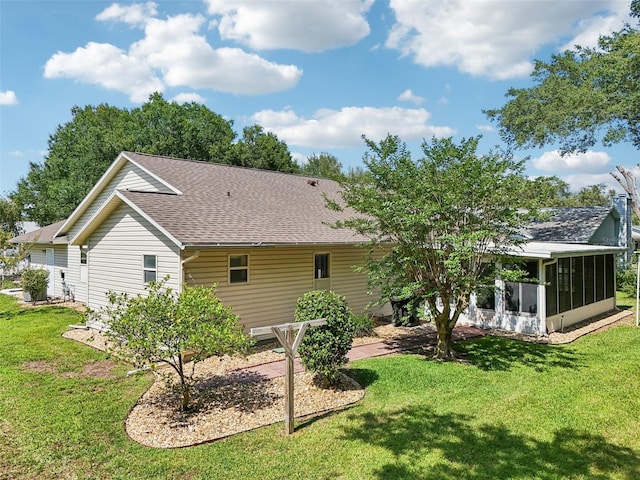 1011 Dundee Cir, Leesburg, FL 34788 - rear view of house with a sunroom, a shingled roof, and a yard