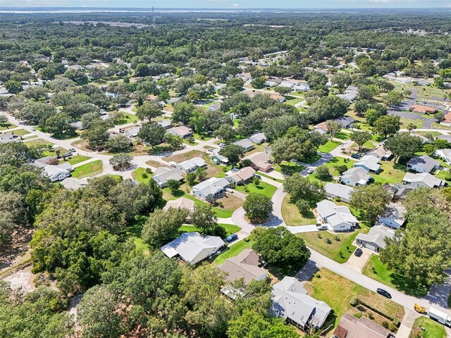 1011 Dundee Cir, Leesburg, FL 34788 - aerial perspective of suburban area featuring a heavily wooded area