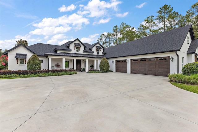 35449 Pinegate Trl, Eustis, FL 32736 - modern inspired farmhouse with a porch, concrete driveway, stucco siding, a standing seam roof, and an attached garage