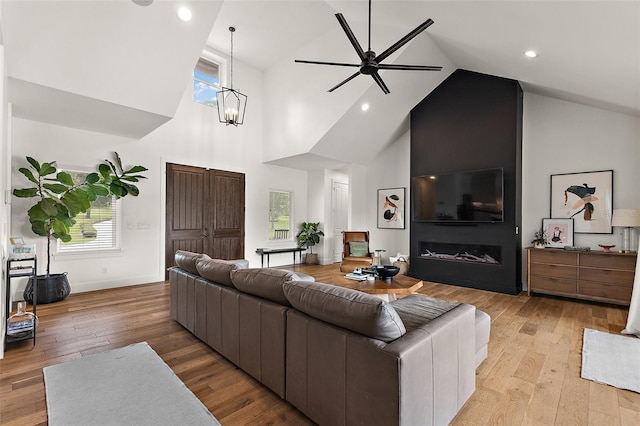 35449 Pinegate Trl, Eustis, FL 32736 - living room featuring high vaulted ceiling, ceiling fan, light wood finished floors, a chandelier, and recessed lighting