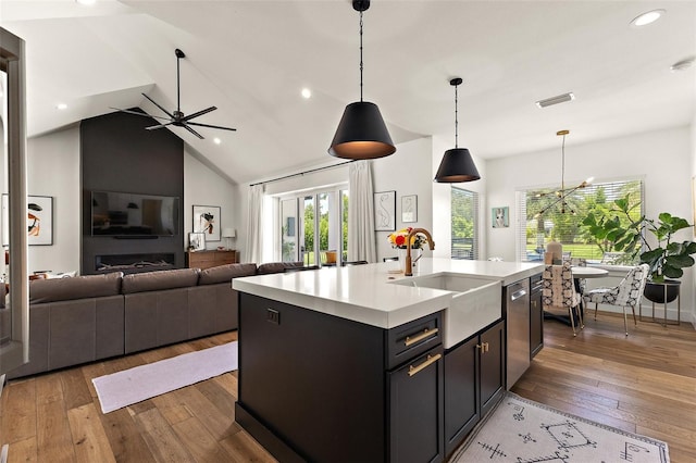 35449 Pinegate Trl, Eustis, FL 32736 - kitchen with light countertops, light wood-type flooring, stainless steel dishwasher, open floor plan, and recessed lighting