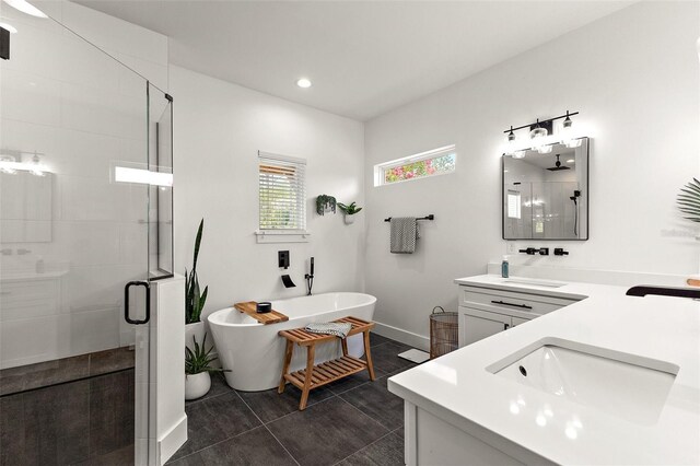 35449 Pinegate Trl, Eustis, FL 32736 - bathroom featuring double vanity, a stall shower, a freestanding bath, and recessed lighting