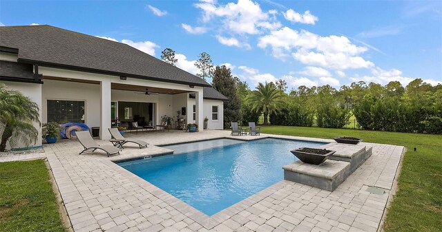 35449 Pinegate Trl, Eustis, FL 32736 - swimming pool with a patio area, a fire pit, a lawn, and a ceiling fan