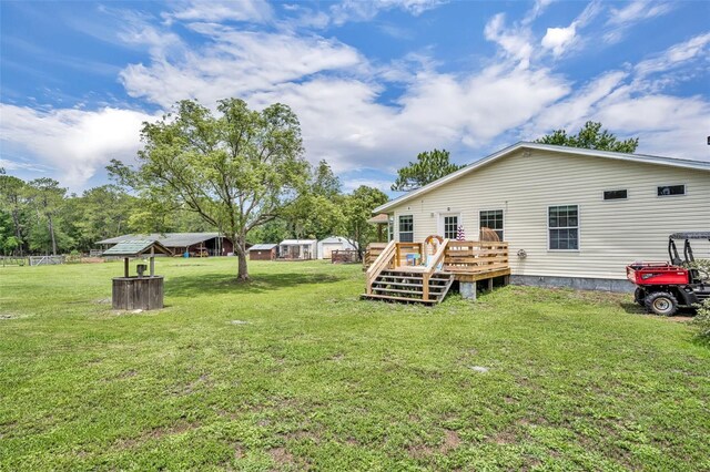 21320 Paradise Way, Eustis, FL 32736 - view of green lawn with a deck