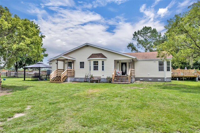 21320 Paradise Way, Eustis, FL 32736 - back of property with crawl space, a gazebo, and roof with shingles