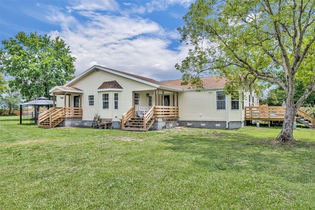 21320 Paradise Way, Eustis, FL 32736 - back of property featuring crawl space, a lawn, a wooden deck, and stairs