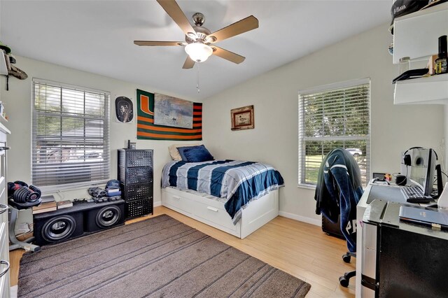 21320 Paradise Way, Eustis, FL 32736 - bedroom featuring multiple windows, wood finished floors, an office area, ceiling fan, and lofted ceiling