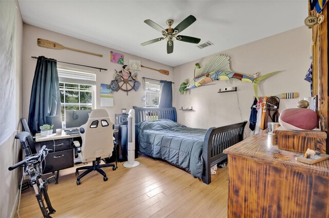 21320 Paradise Way, Eustis, FL 32736 - bedroom with wood finished floors, a desk, and a ceiling fan