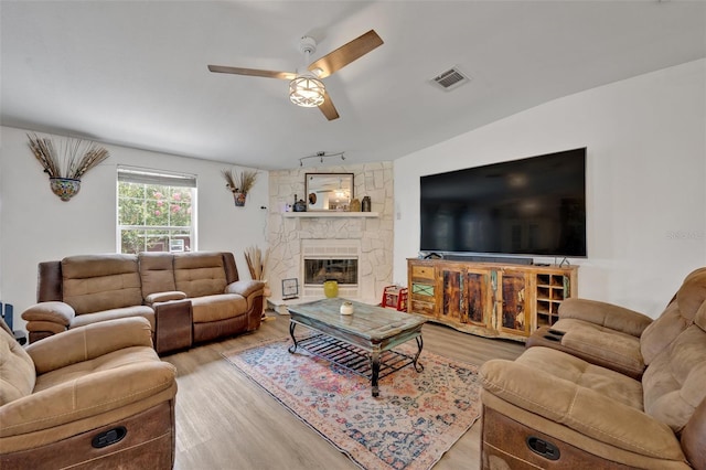 21320 Paradise Way, Eustis, FL 32736 - living area featuring a ceiling fan, wood finished floors, and a fireplace