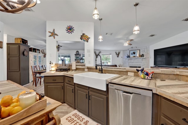 21320 Paradise Way, Eustis, FL 32736 - kitchen with stainless steel dishwasher, ceiling fan, a sink, open floor plan, and a stone fireplace
