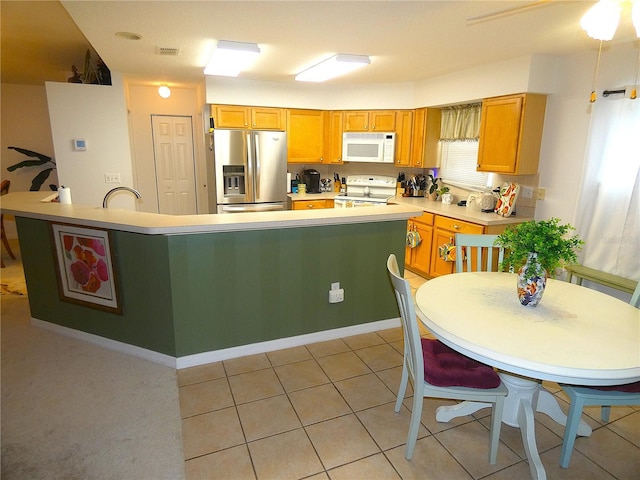 751 Old Oaks Ln, Leesburg, FL 34748 - kitchen featuring white appliances, light countertops, a sink, light tile patterned flooring, and a kitchen island