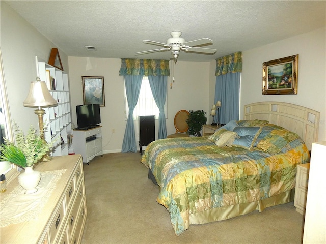 751 Old Oaks Ln, Leesburg, FL 34748 - bedroom with light colored carpet, a textured ceiling, and a ceiling fan