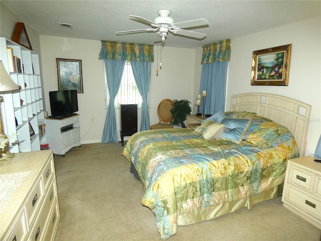 751 Old Oaks Ln, Leesburg, FL 34748 - bedroom with light colored carpet, ceiling fan, and a textured ceiling