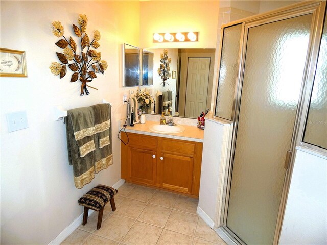 751 Old Oaks Ln, Leesburg, FL 34748 - full bath featuring vanity, tile patterned flooring, a stall shower, and baseboards
