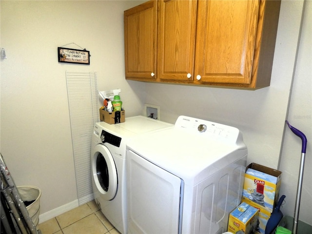 751 Old Oaks Ln, Leesburg, FL 34748 - washroom featuring washing machine and clothes dryer, cabinet space, light tile patterned floors, and baseboards