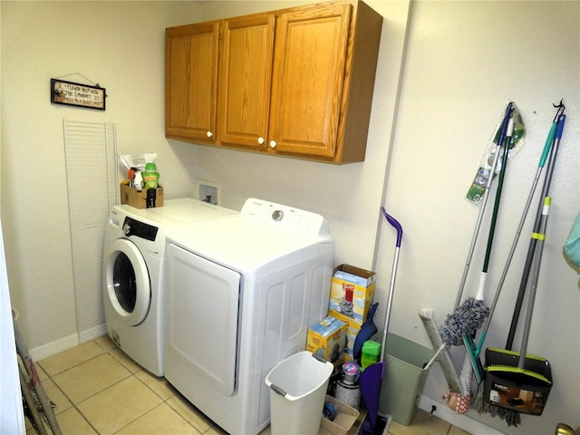 751 Old Oaks Ln, Leesburg, FL 34748 - washroom featuring washing machine and dryer, cabinet space, light tile patterned flooring, and baseboards