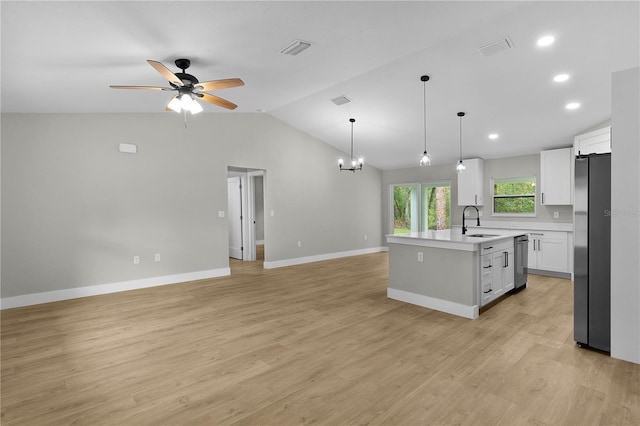 1115 W Geneva Pl, Citrus Springs, FL 34434 - kitchen featuring a sink, stainless steel appliances, open floor plan, lofted ceiling, and light countertops