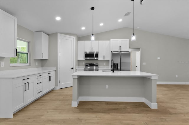 1115 W Geneva Pl, Citrus Springs, FL 34434 - kitchen with stainless steel appliances, white cabinets, a sink, light countertops, and light wood-style floors