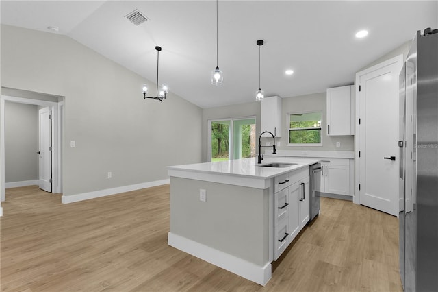 1115 W Geneva Pl, Citrus Springs, FL 34434 - kitchen with a sink, lofted ceiling, appliances with stainless steel finishes, white cabinetry, and light countertops