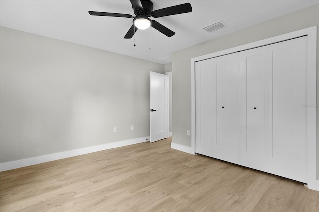 1115 W Geneva Pl, Citrus Springs, FL 34434 - unfurnished bedroom featuring light wood finished floors, a closet, baseboards, and a ceiling fan