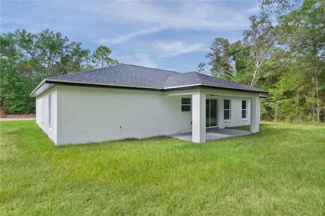 1115 W Geneva Pl, Citrus Springs, FL 34434 - rear view of property with roof with shingles, a patio area, stucco siding, and a lawn