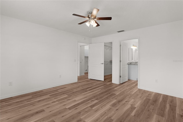 1313 Arredondo Dr, The Villages, FL 32162 - unfurnished bedroom with light wood-type flooring, baseboards, a spacious closet, a closet, and ceiling fan