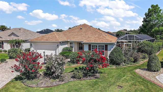 1175 Johnston Path, The Villages, FL 32162 - view of front of property with an attached garage, a front yard, driveway, and a lanai