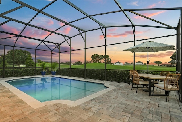 17700 Sawgrass Run, Tavares, FL 32778 - outdoor pool featuring a patio area, glass enclosure, and outdoor dining space