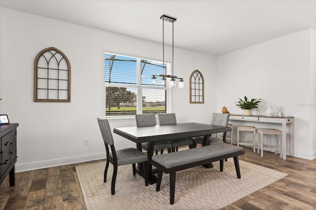 17700 Sawgrass Run, Tavares, FL 32778 - dining room with dark wood-style flooring and a chandelier