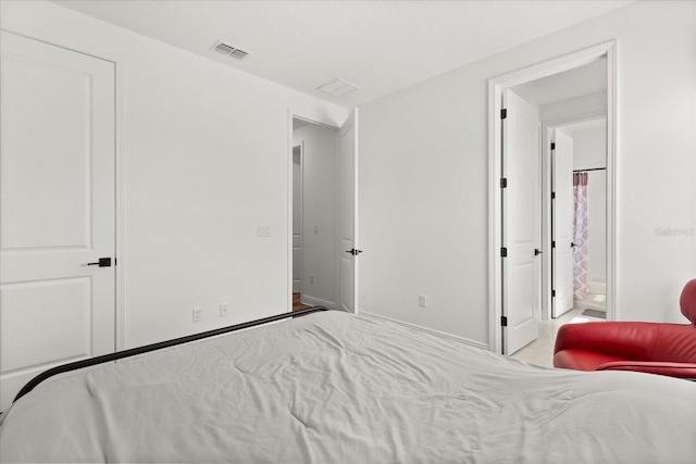 17700 Sawgrass Run, Tavares, FL 32778 - bedroom with baseboards and connected bathroom