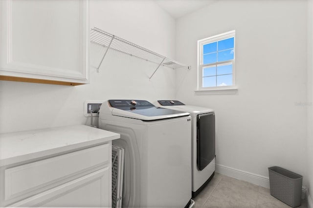 17700 Sawgrass Run, Tavares, FL 32778 - washroom with cabinet space, washer and clothes dryer, and light tile patterned floors