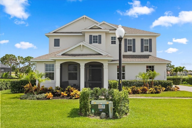 17700 Sawgrass Run, Tavares, FL 32778 - traditional-style home with stucco siding, roof with shingles, and a front lawn