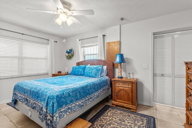 2542 N Regatta Pt, Crystal River, FL 34429 - bedroom featuring baseboards, light tile patterned floors, ceiling fan, and a textured ceiling