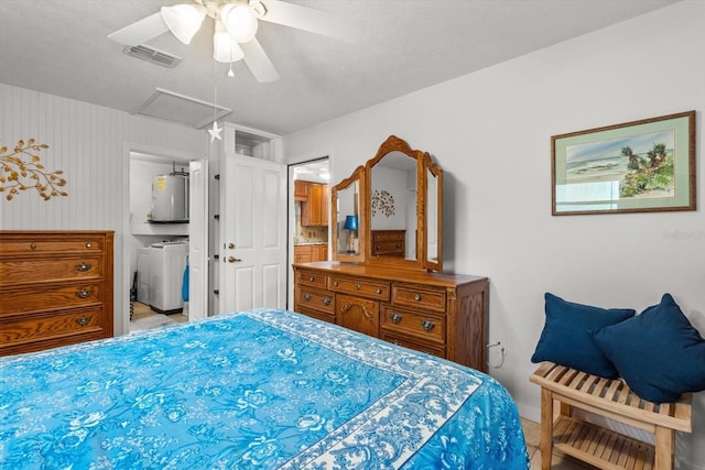 2542 N Regatta Pt, Crystal River, FL 34429 - bedroom featuring attic access, water heater, washing machine and dryer, a ceiling fan, and baseboards