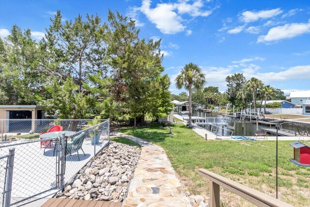 2542 N Regatta Pt, Crystal River, FL 34429 - view of yard with a water view, a patio, a boat dock, and boat lift