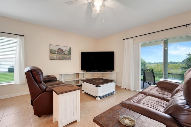 641 Black Eagle Dr, Groveland, FL 34736 - living room featuring light tile patterned floors, ceiling fan, and baseboards