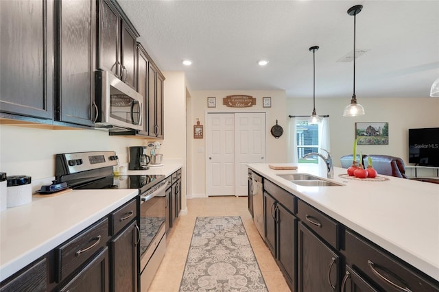 641 Black Eagle Dr, Groveland, FL 34736 - kitchen featuring appliances with stainless steel finishes, a sink, light countertops, decorative light fixtures, and recessed lighting