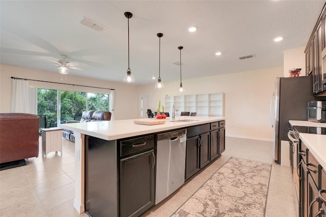641 Black Eagle Dr, Groveland, FL 34736 - kitchen with stainless steel appliances, a sink, open floor plan, light countertops, and recessed lighting