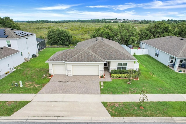 641 Black Eagle Dr, Groveland, FL 34736 - view of front of property featuring driveway, a garage, stucco siding, and stone siding