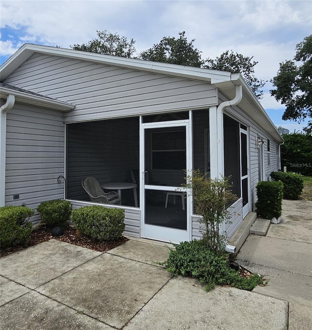 2105 Escobar Ave, The Villages, FL 32159 - view of home's exterior with a sunroom and entry steps