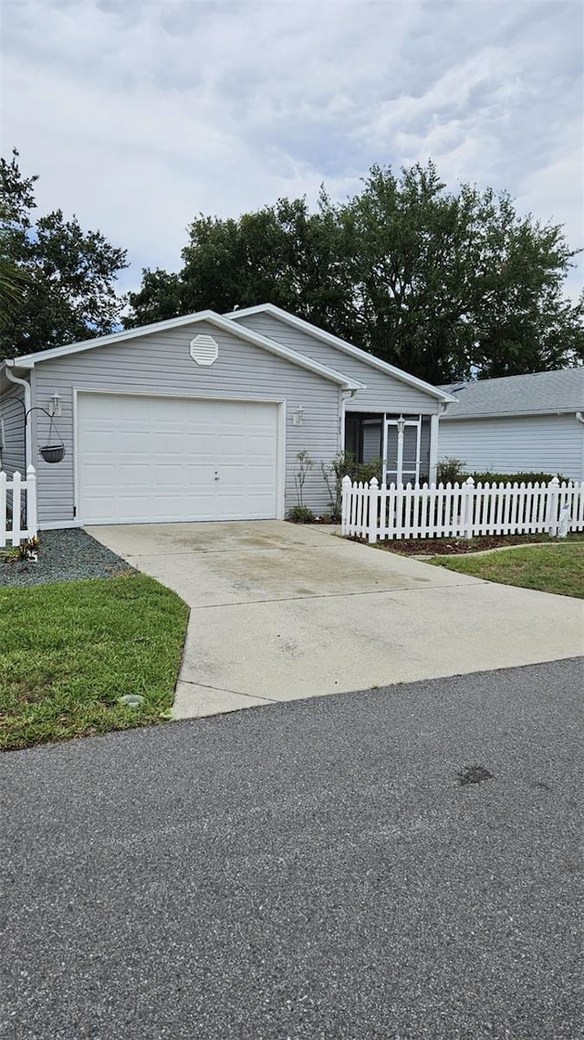 2105 Escobar Ave, The Villages, FL 32159 - view of front of property with a garage and driveway
