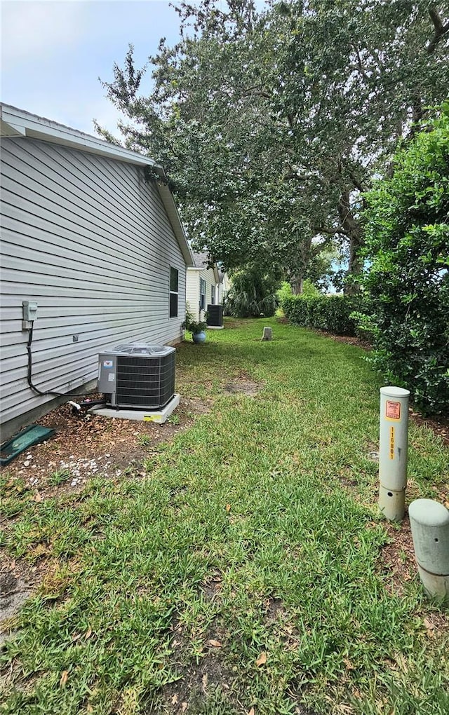 2105 Escobar Ave, The Villages, FL 32159 - view of green lawn with central AC unit