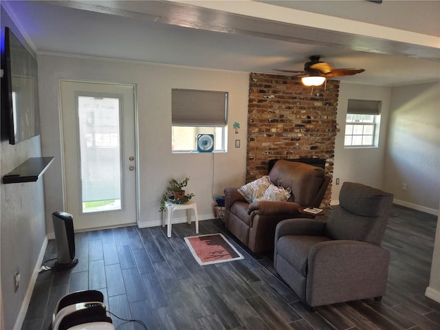 504 SE 35th Ave, Ocala, FL 34471 - living room with dark wood-style flooring, ceiling fan, baseboards, crown molding, and a fireplace