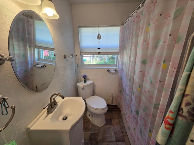 504 SE 35th Ave, Ocala, FL 34471 - bathroom with stone finish floors, toilet, vanity, and a textured wall