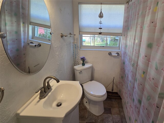 504 SE 35th Ave, Ocala, FL 34471 - full bathroom featuring a textured wall, vanity, stone finish flooring, and a shower with shower curtain