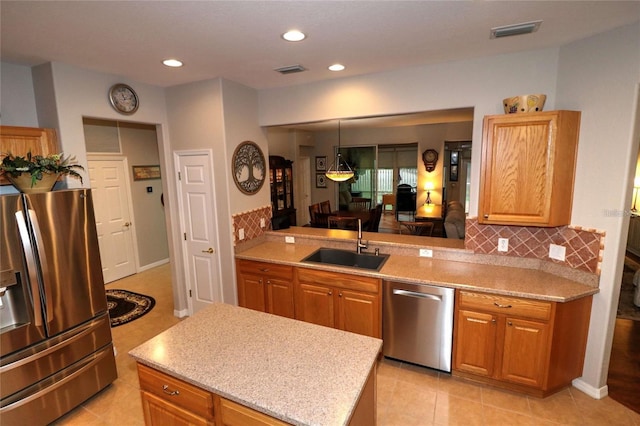 11868 SE 91st Cir, Summerfield, FL 34491 - kitchen with stainless steel appliances, a sink, decorative backsplash, a kitchen island, and recessed lighting