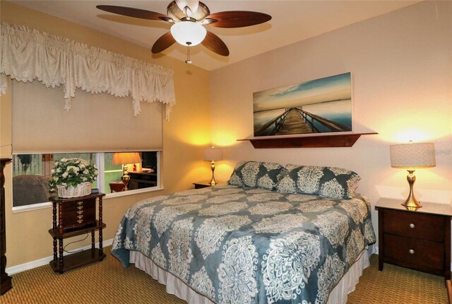 11868 SE 91st Cir, Summerfield, FL 34491 - bedroom with carpet floors, baseboards, and ceiling fan