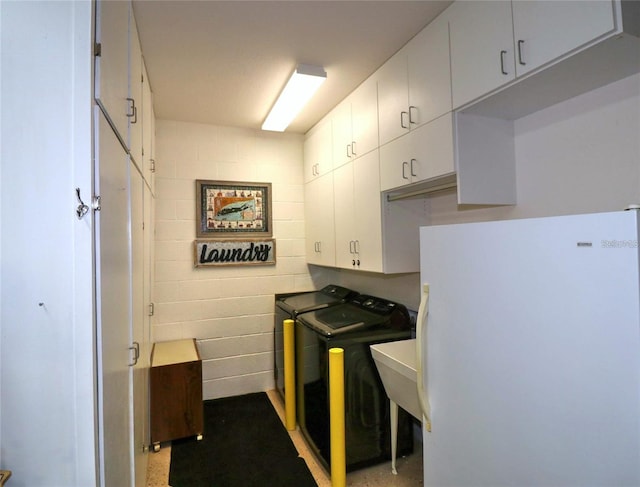 11868 SE 91st Cir, Summerfield, FL 34491 - washroom with separate washer and dryer, cabinet space, and concrete block wall